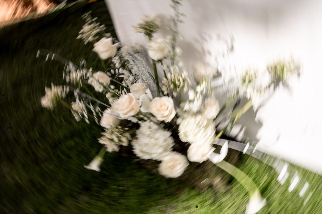 Artistic editorial photograph of a bridal bouquet in motion during a destination wedding at Claustros de Ayllón, planned by Bamboleo Weddings￼.